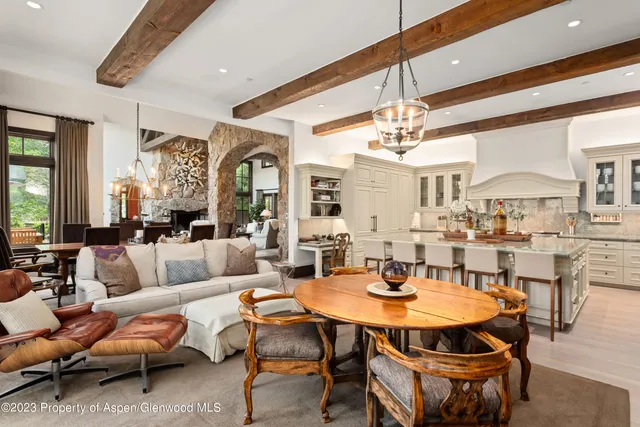 a living room with fireplace furniture and a large window