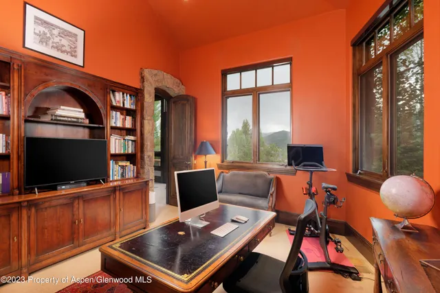 a bedroom with furniture and a flat screen tv