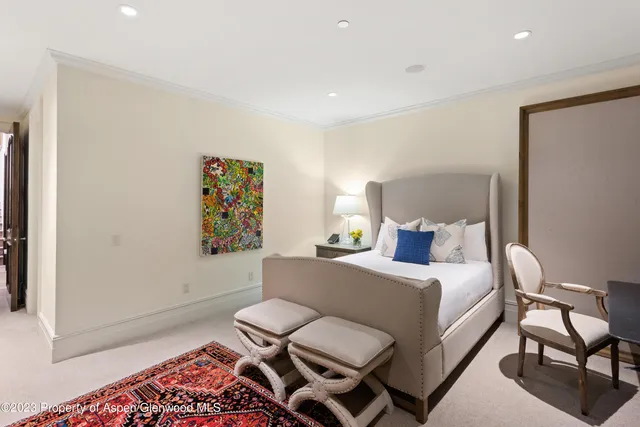 a living room with furniture fireplace and a large window