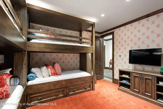 a kitchen with a table chairs and a refrigerator