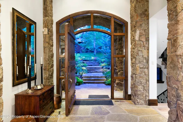 a living room with furniture fireplace and a large window