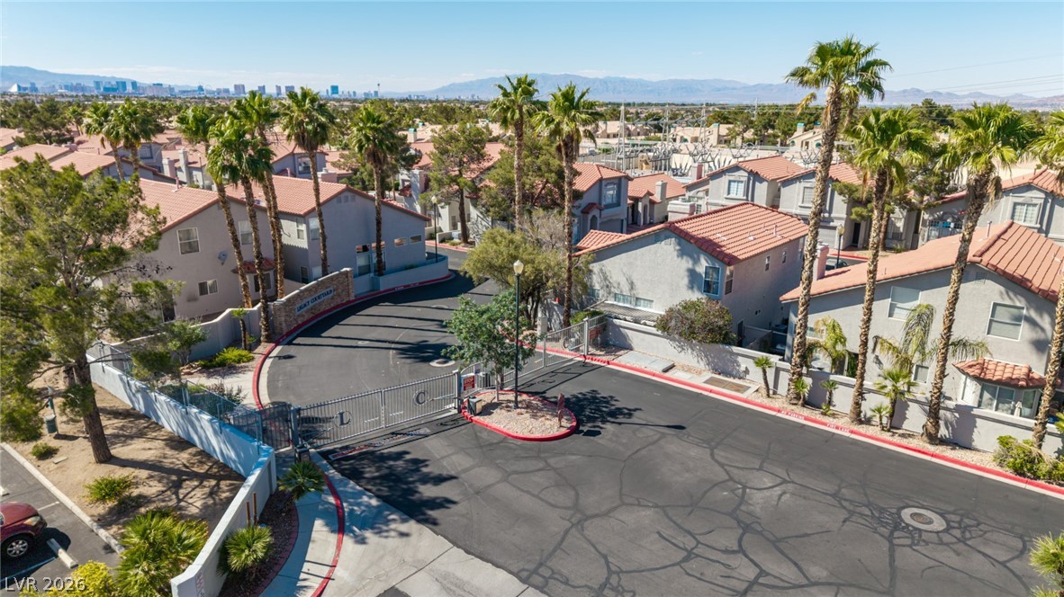 2223 Ramsgate Drive Henderson, NV 89074 - Photo 27 of 32 Secure community entrance with an inviting gated entry, flanked by lush palm trees.