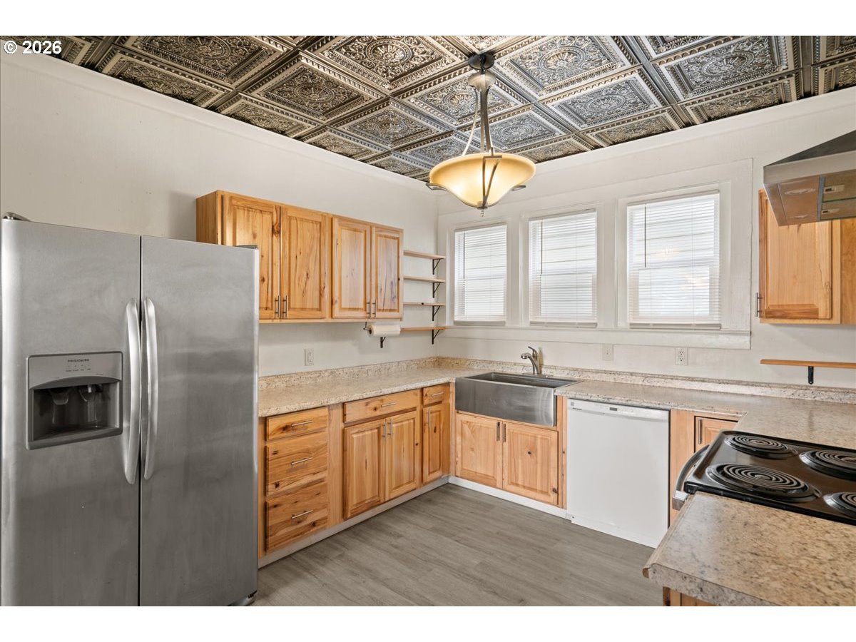 1280 4th Street Northeast Salem, OR 97301 - Photo 12 of 44 a kitchen with stainless steel appliances granite countertop a sink a stove and refrigerator