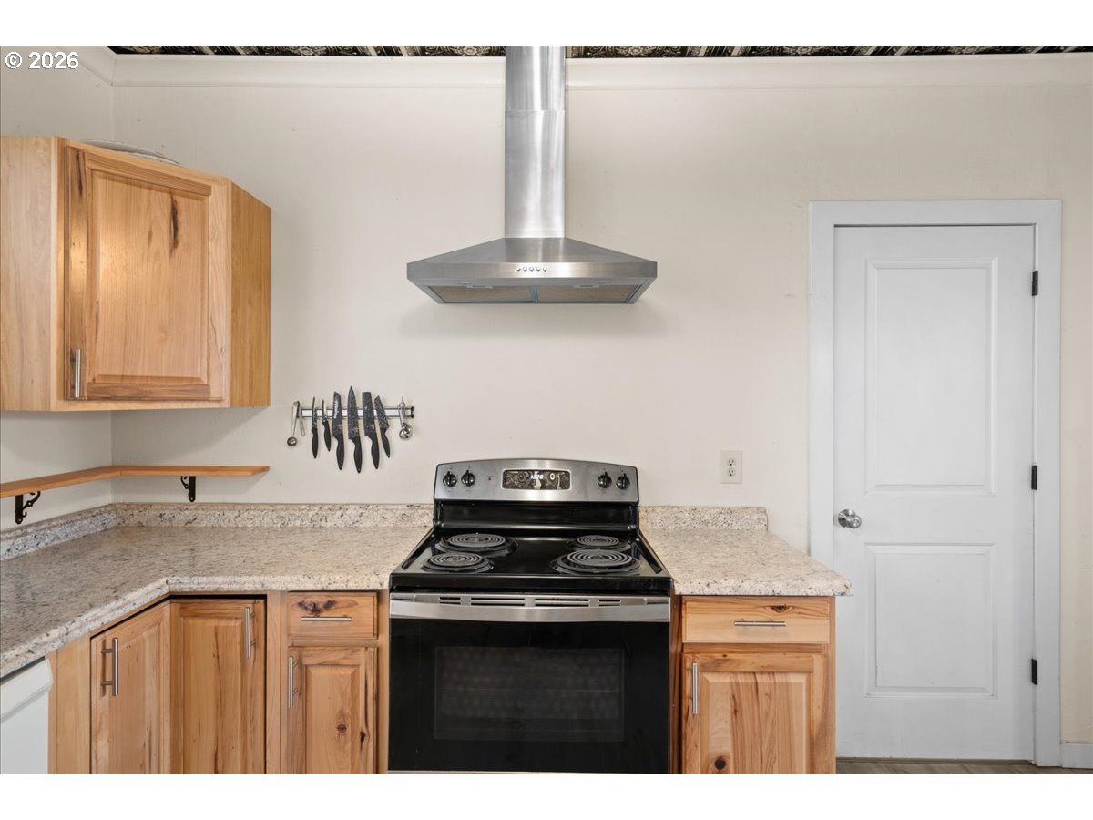 1280 4th Street Northeast Salem, OR 97301 - Photo 13 of 44 a kitchen with granite countertop a sink a stove and cabinets