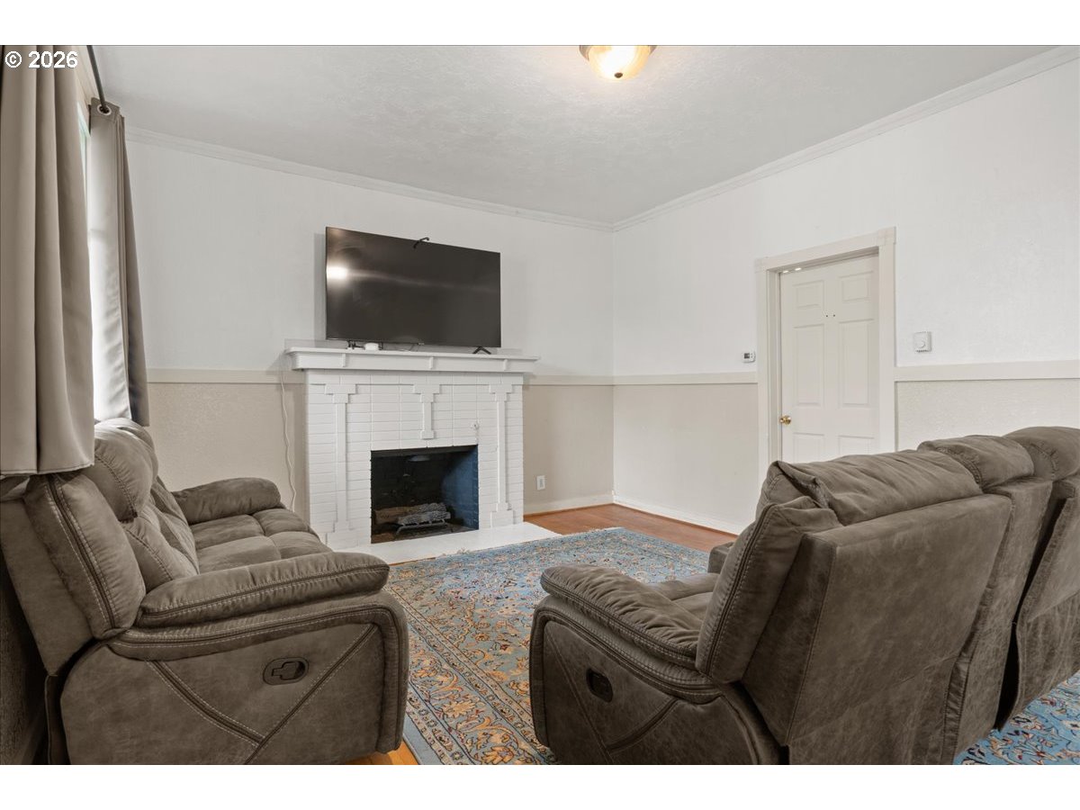 1280 4th Street Northeast Salem, OR 97301 - Photo 15 of 44 a living room with furniture a flat screen tv and a fireplace