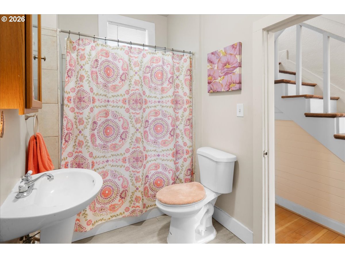 1280 4th Street Northeast Salem, OR 97301 - Photo 22 of 44 a bathroom with a toilet sink and shower curtain