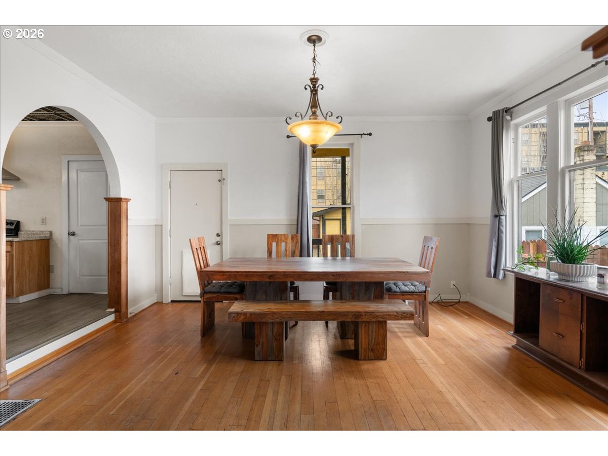 1280 4th Street Northeast Salem, OR 97301 - Photo 8 of 44 a dining room with wooden floor a chandelier a wooden table and chairs