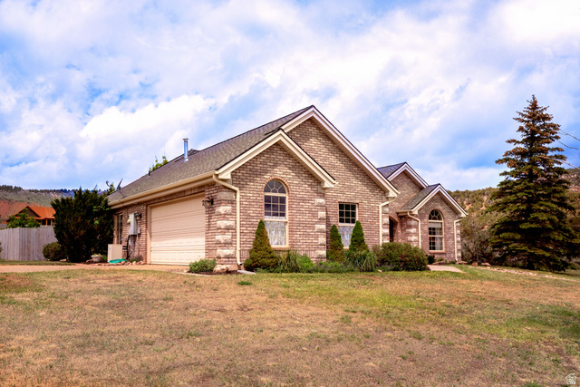 7343 North Sawtooth Cv Road Vernal, UT 84078 - Photo 51 of 64 Brick exterior featuring stone accents and arched windows