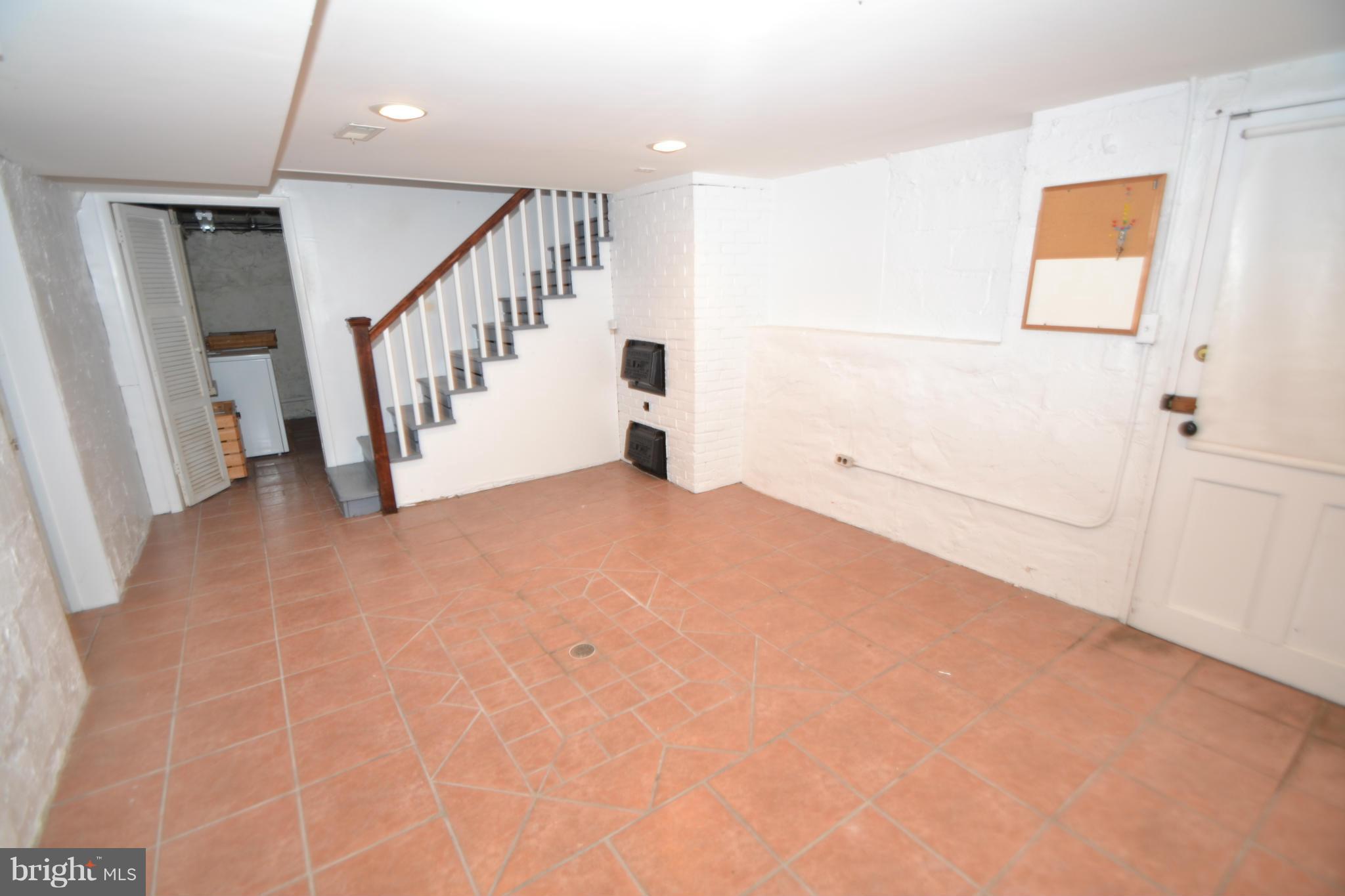 4417 Underwood Road Baltimore, MD 21218 - Photo 22 of 29 a view of an empty room with stairs