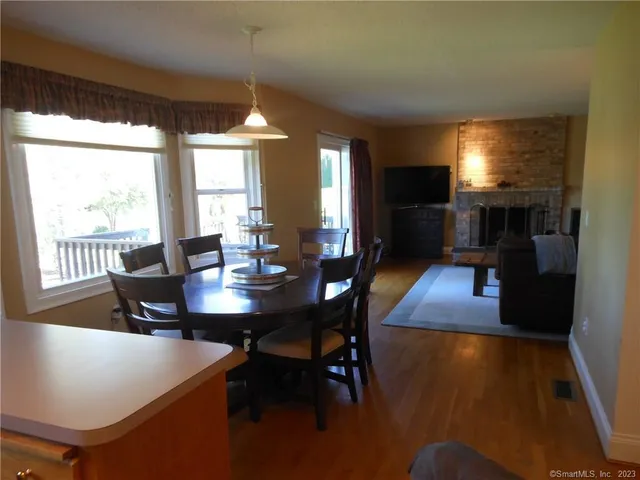 a view of a dining room with furniture window and wooden floor