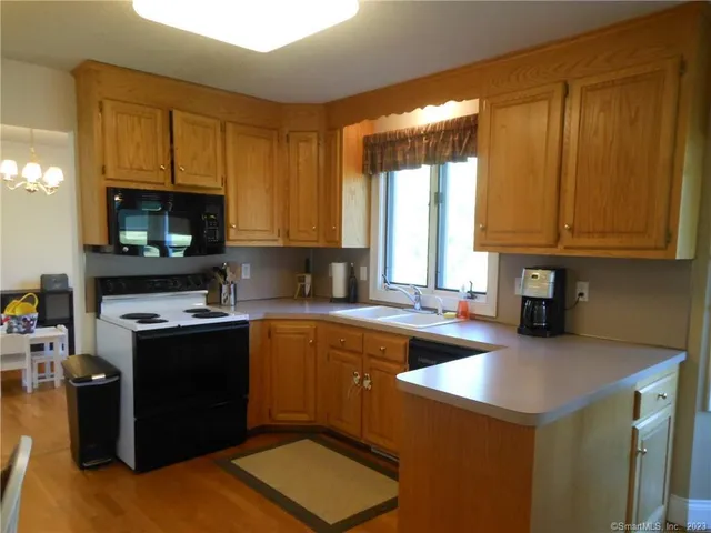 a dining room with furniture window and wooden floor