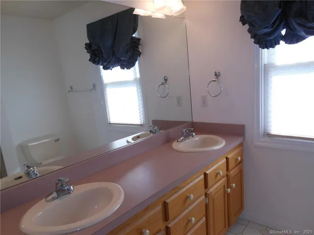 a view of an empty room with a chandelier fan