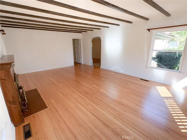 a view of a room with wooden floor and windows