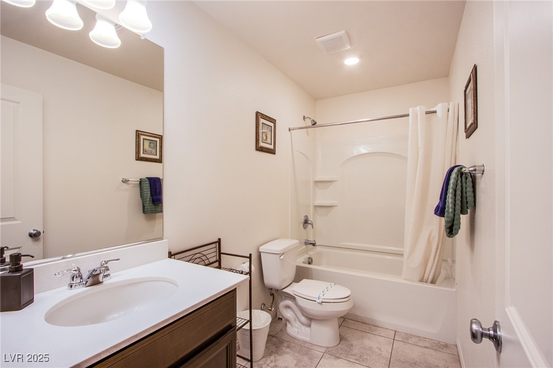 9858 West Meranto Avenue Las Vegas, NV 89178 - Photo 23 of 36 Full bathroom featuring shower / bath combination with curtain, light tile patterned floors, and vanity