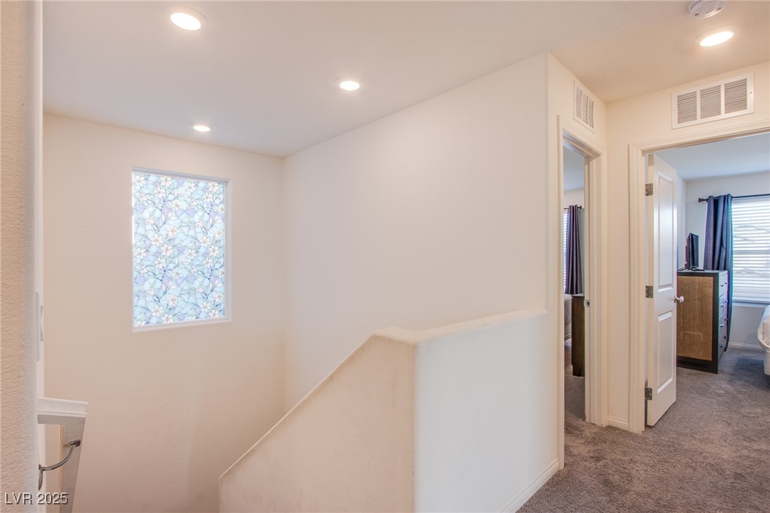 9858 West Meranto Avenue Las Vegas, NV 89178 - Photo 30 of 36 Hall with an upstairs landing, dark colored carpet, and recessed lighting