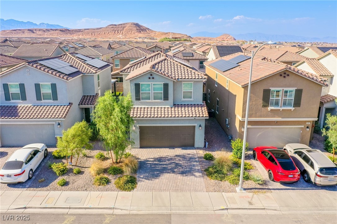 9858 West Meranto Avenue Las Vegas, NV 89178 - Photo 3 of 36 Mediterranean / spanish-style home with a residential view, an attached garage, stucco siding, and decorative driveway