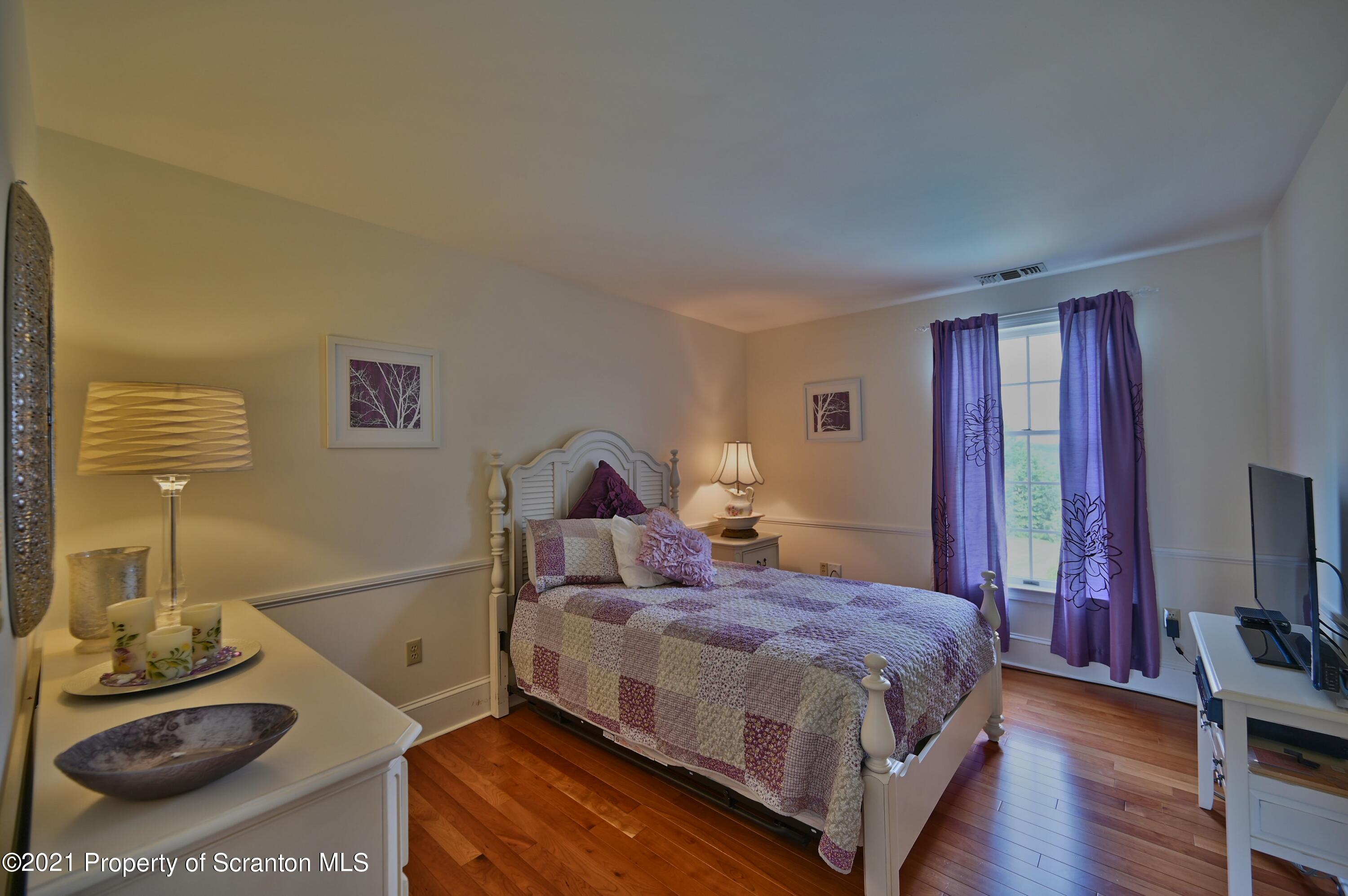 454 Twin Rocks Road Sterling, PA 18463 - Photo 46 of 102 a bedroom with a bed and wooden floor