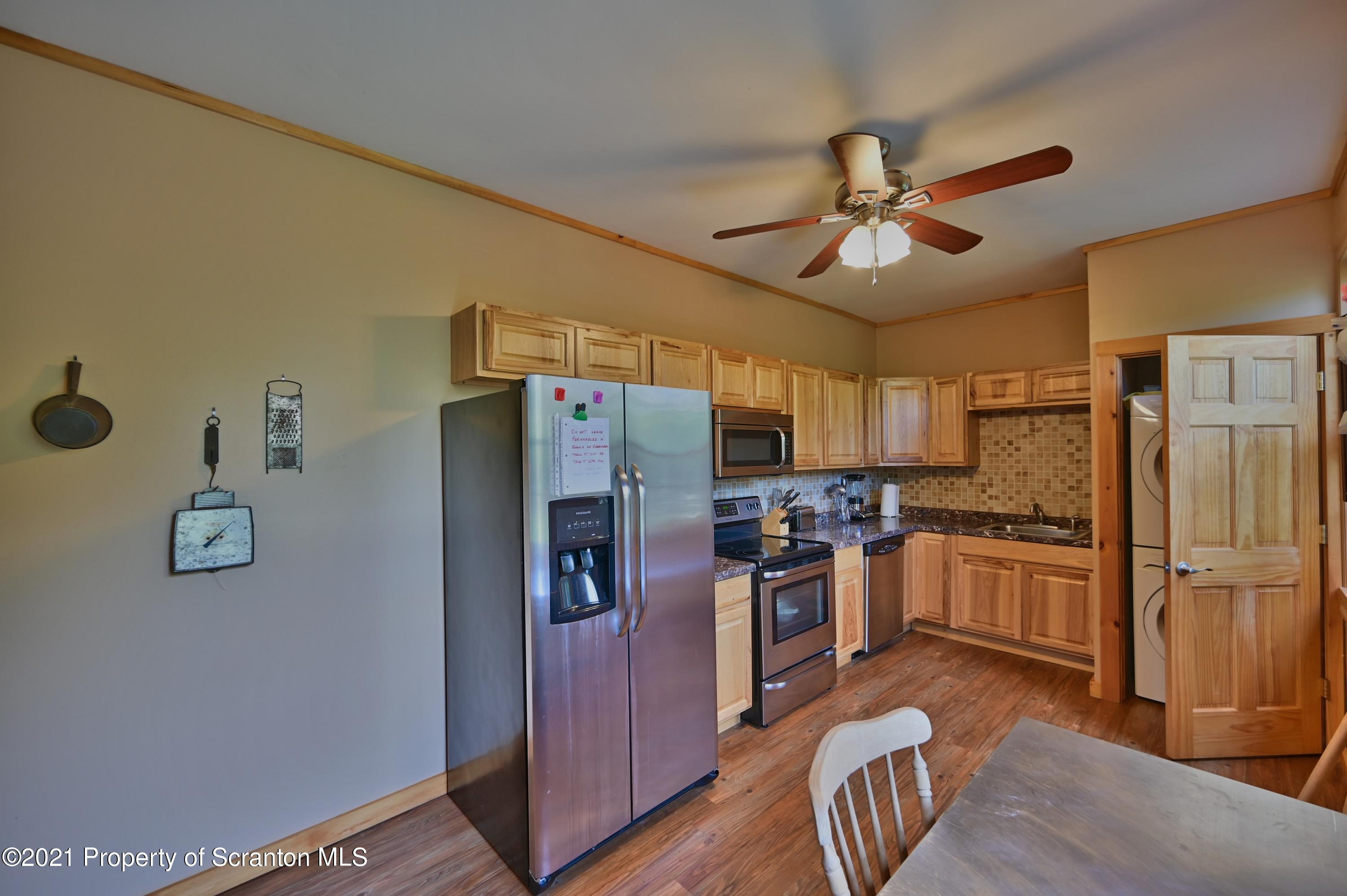 454 Twin Rocks Road Sterling, PA 18463 - Photo 73 of 102 a kitchen with refrigerator a stove and a microwave