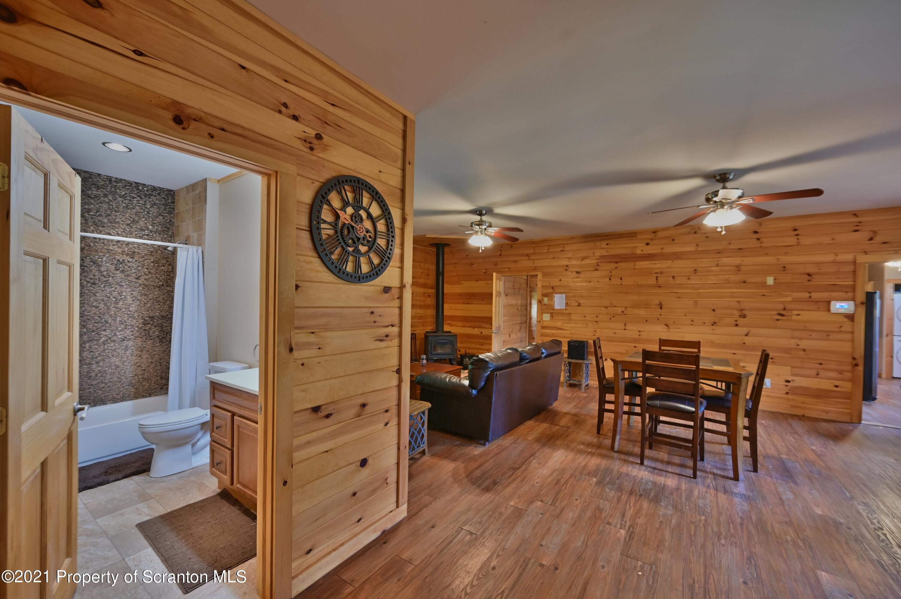 454 Twin Rocks Road Sterling, PA 18463 - Photo 77 of 102 a view of a livingroom with furniture and wooden floor