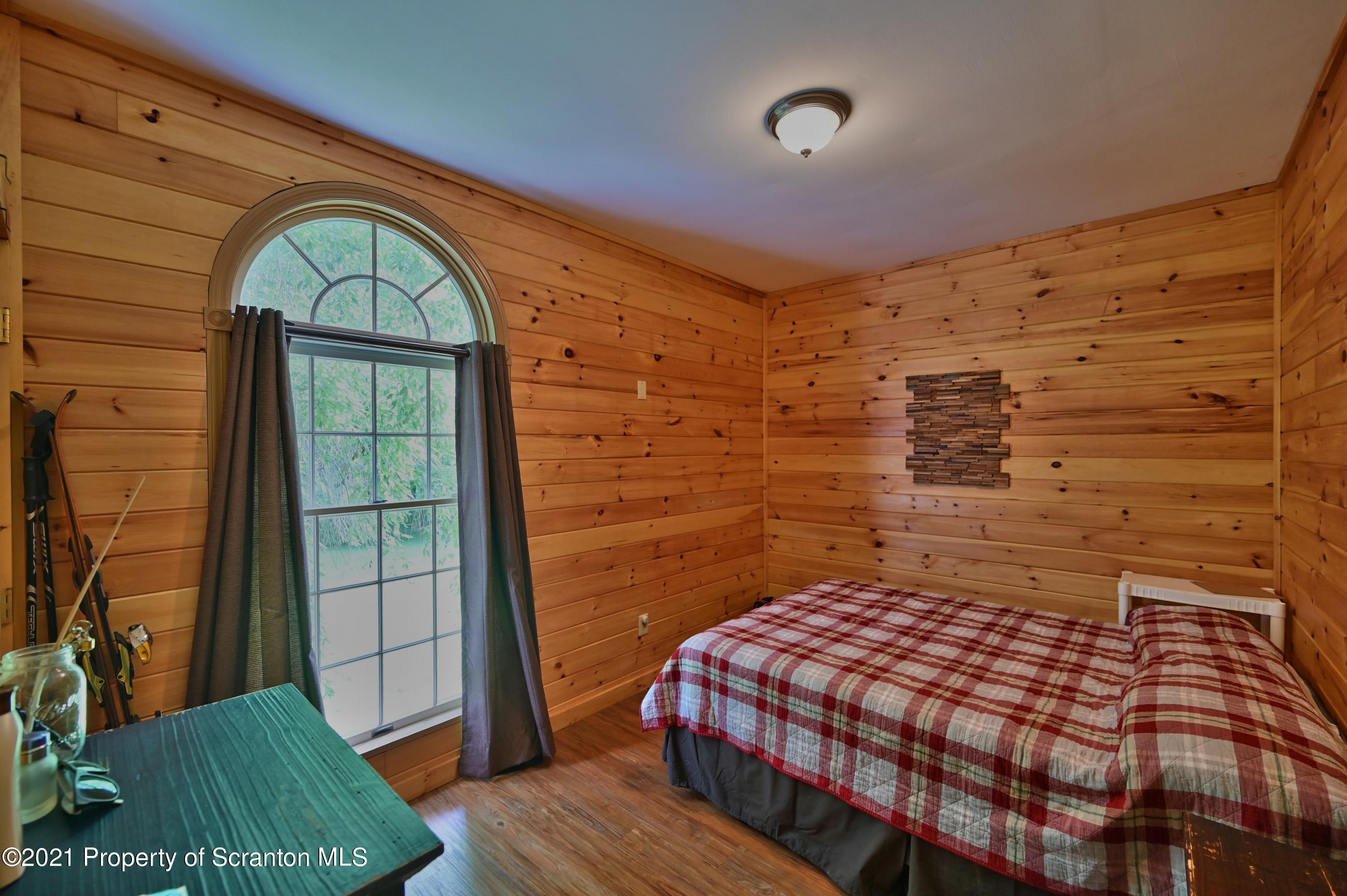 454 Twin Rocks Road Sterling, PA 18463 - Photo 84 of 102 a bedroom with a bed and a dresser