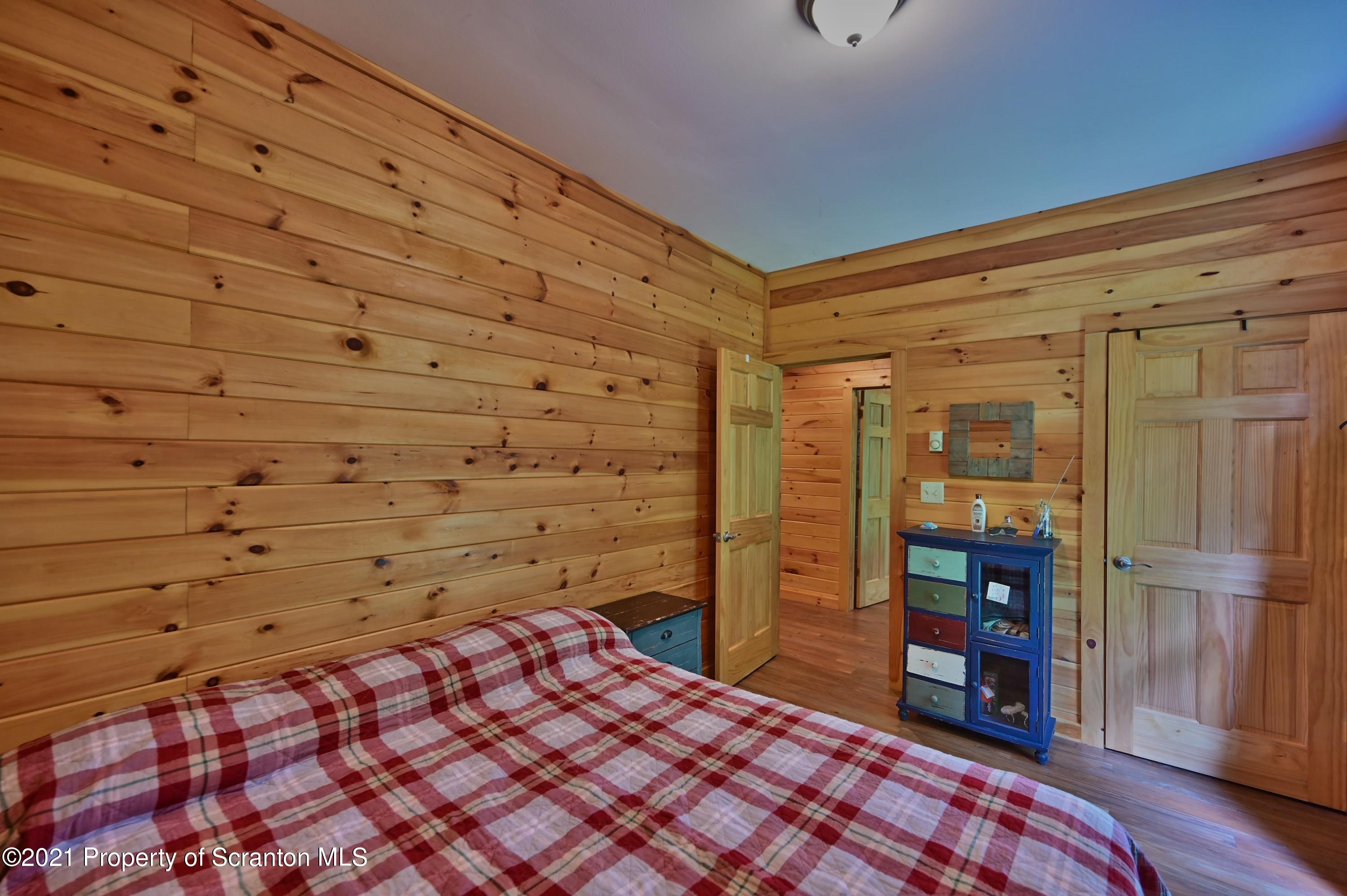 454 Twin Rocks Road Sterling, PA 18463 - Photo 85 of 102 a bedroom with a bed and wooden floor