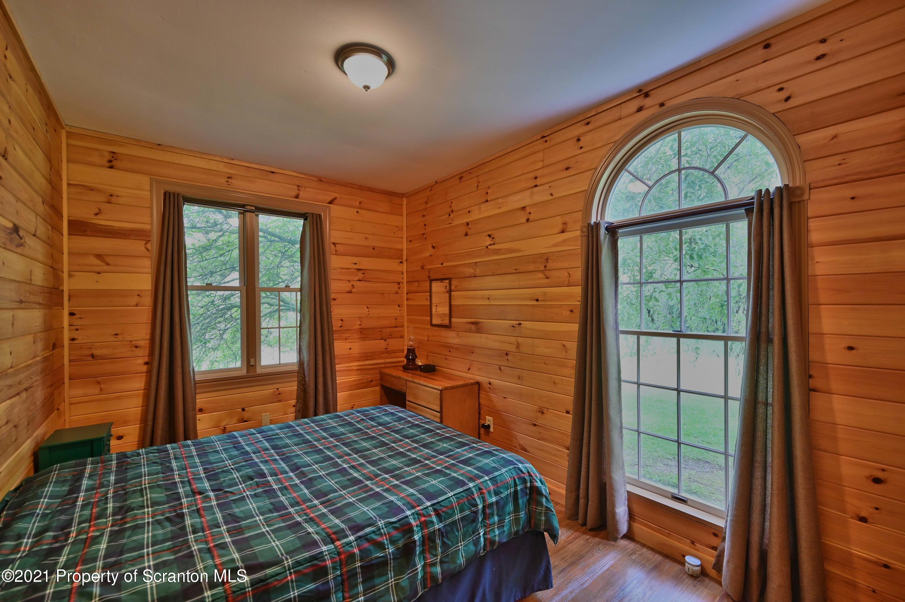 454 Twin Rocks Road Sterling, PA 18463 - Photo 86 of 102 a bedroom with a bed and wooden floor