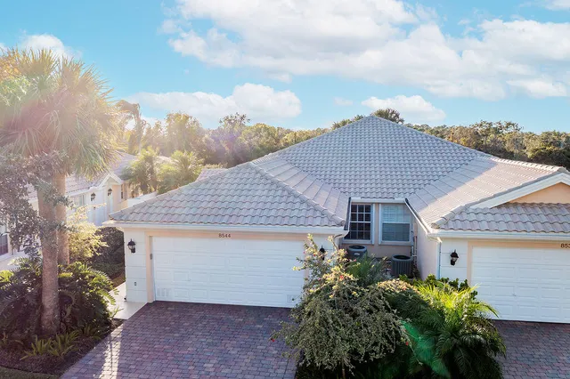 an aerial view of a house with swimming pool and outdoor space