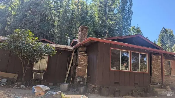 a front view of a house with trees