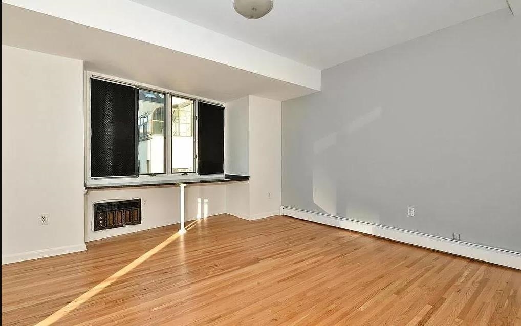80 Bloomfield Street, Unit 4B Hoboken, NJ 07030 - Photo 7 of 11 a view of an empty room with wooden floor and a window