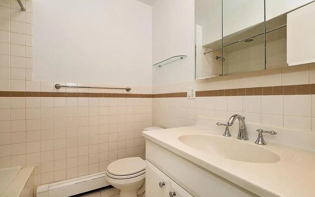 80 Bloomfield Street, Unit 4B Hoboken, NJ 07030 - Photo 9 of 11 a bathroom with a sink a toilet and shower