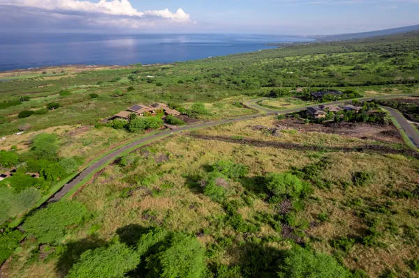 a view of a field with an ocean