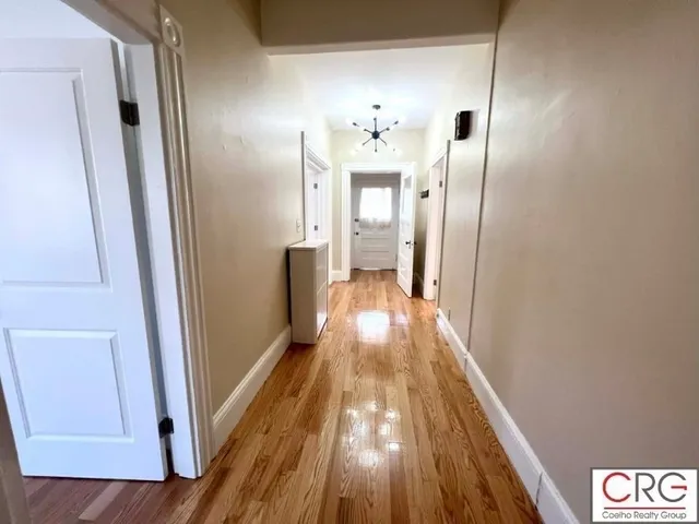 a view of a hallway view with wooden floor