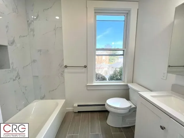 a bathroom with a sink a toilet and a bathtub