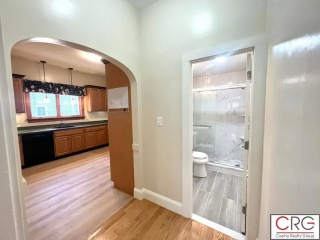 a view of a kitchen from a hallway