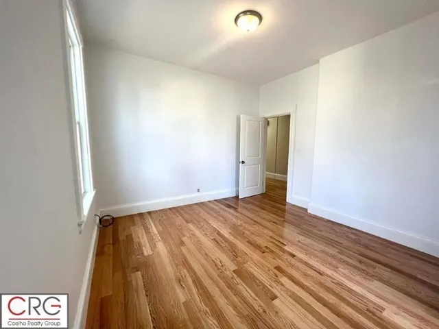 a view of an empty room and wooden floor