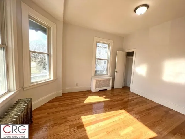 a view of a livingroom with wooden floor and a window