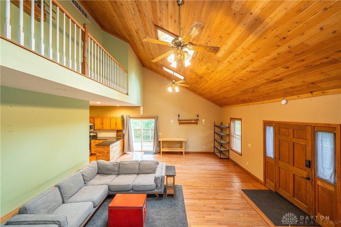 10584 New Biddinger Road Harrison, OH 45030 - Photo 7 of 61 This airy great room features high ceilings and an open-concept design with wooden flooring.