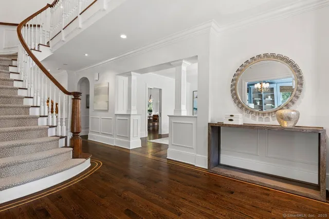 a view of entryway and hall with wooden floor