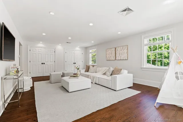 a living room with fireplace furniture and a wooden floor