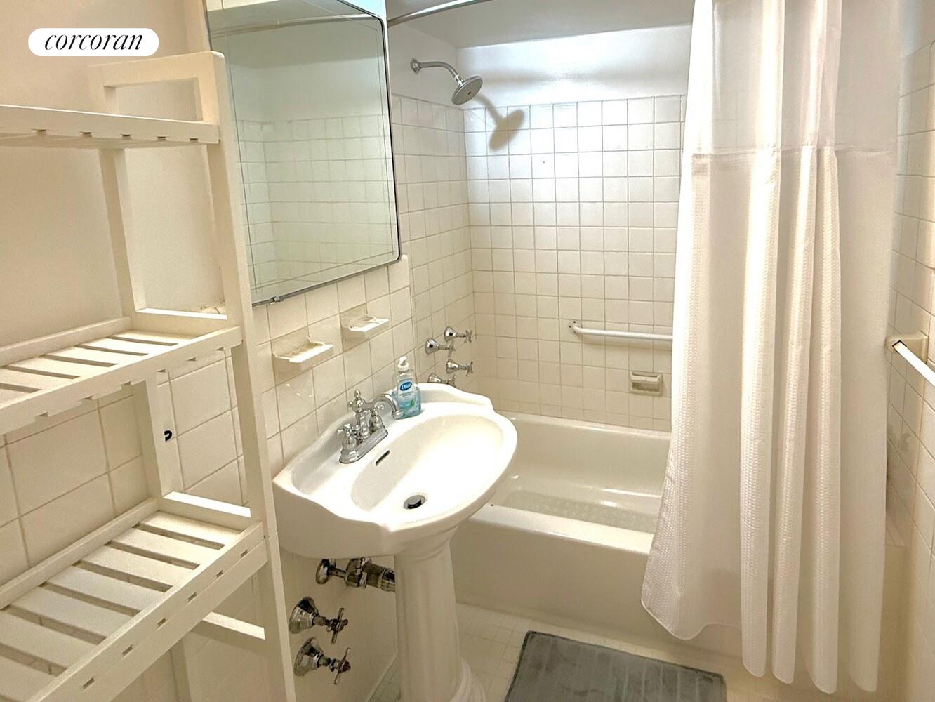 65 East 76th Street, Unit 2C Manhattan, NY 10021 - Photo 4 of 7 a bathroom with a sink a mirror and a shower