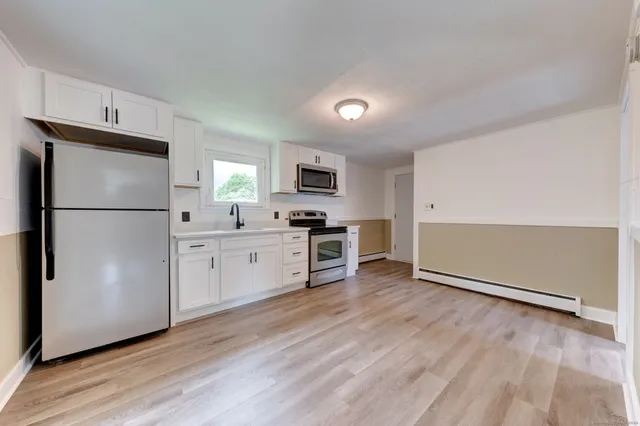 a kitchen with a refrigerator a stove top oven a sink and dishwasher