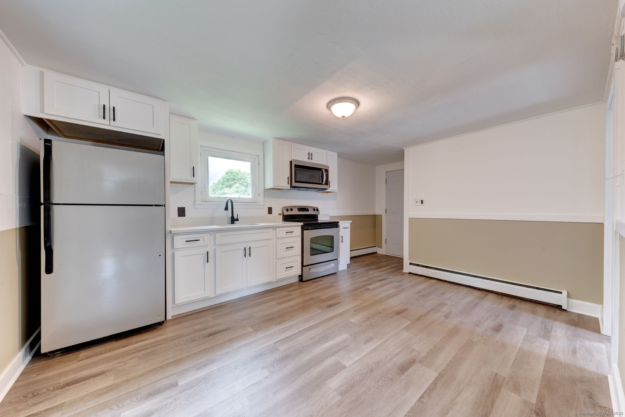 40 Mortimer Street, Unit 3 Torrington, CT 06790 - Photo 3 of 20 a kitchen with a refrigerator a stove top oven a sink and dishwasher