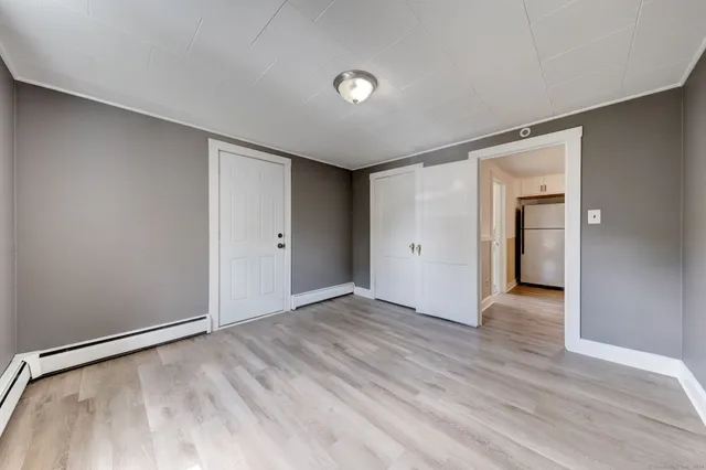 a view of an empty room with wooden floor