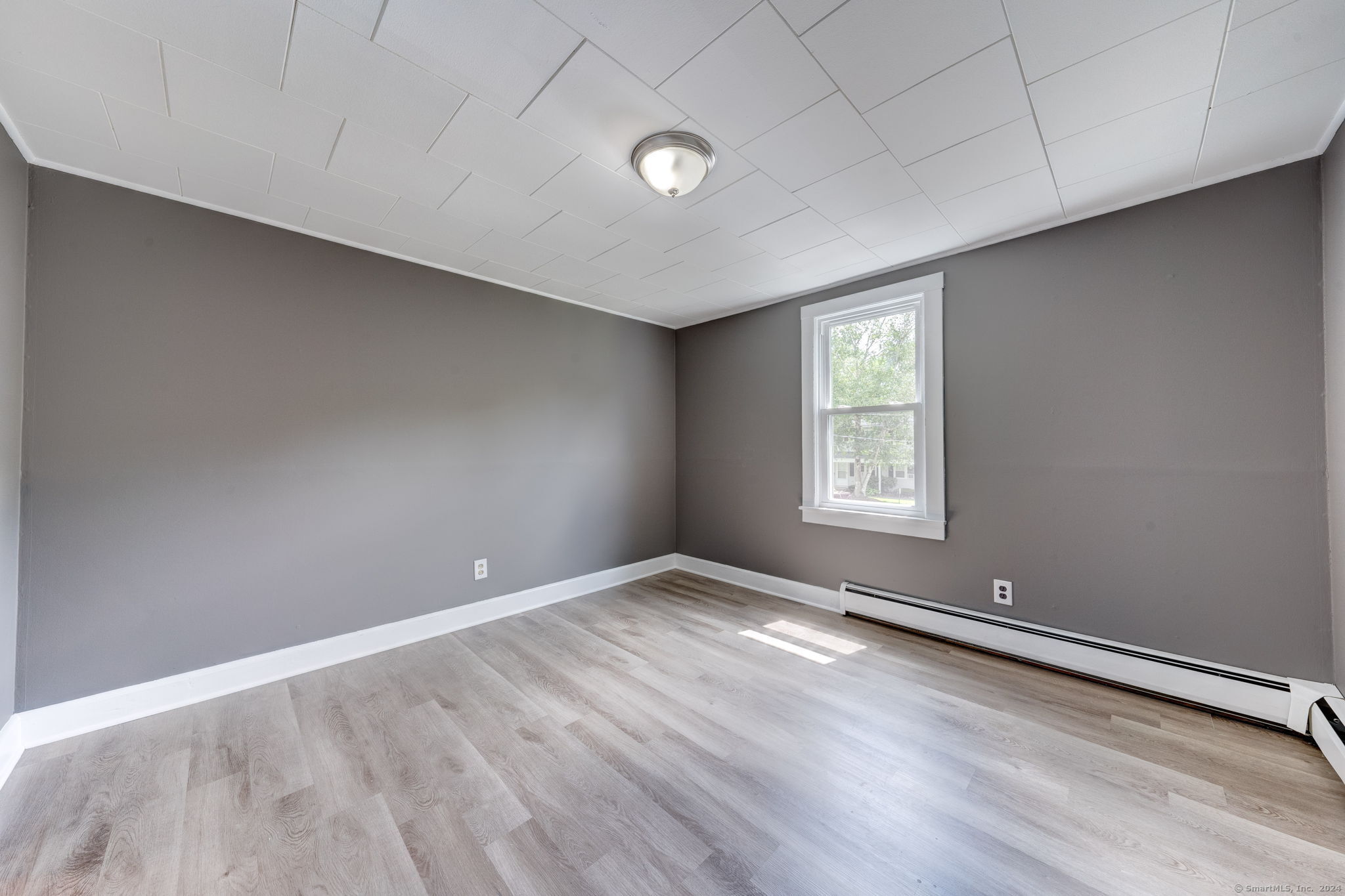 40 Mortimer Street, Unit 3 Torrington, CT 06790 - Photo 8 of 20 wooden floor in an empty room with a window