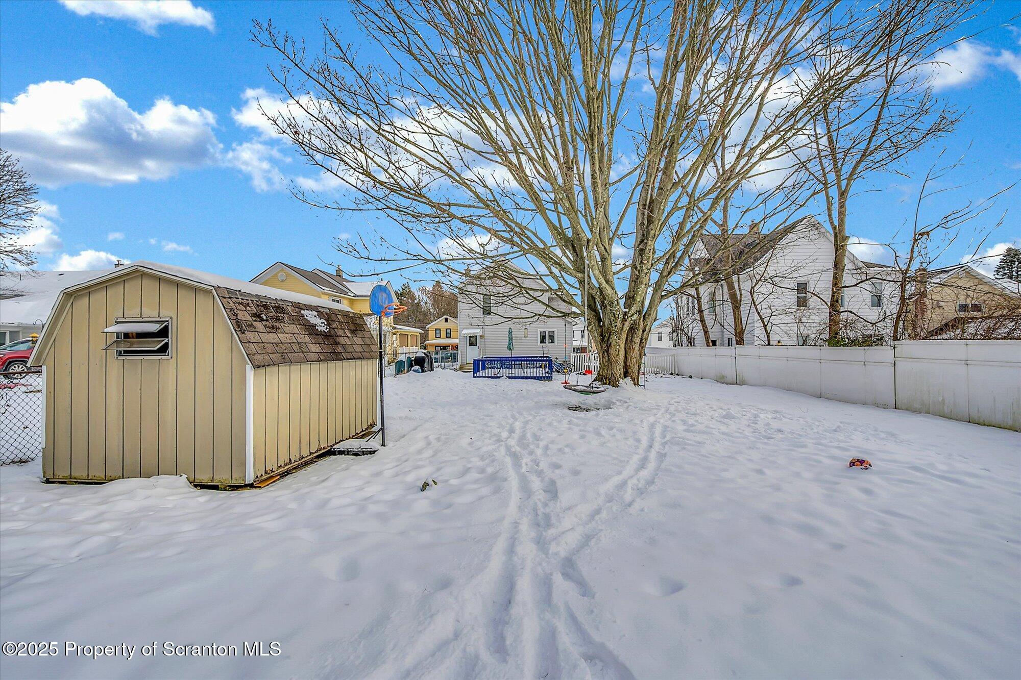 219 1st Street Olyphant, PA 18447 - Photo 13 of 43 a view of a parking space with wooden fence