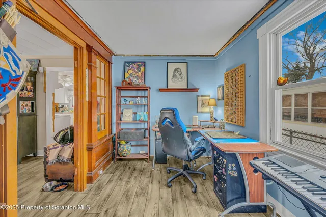 a view of a workspace with furniture and a window