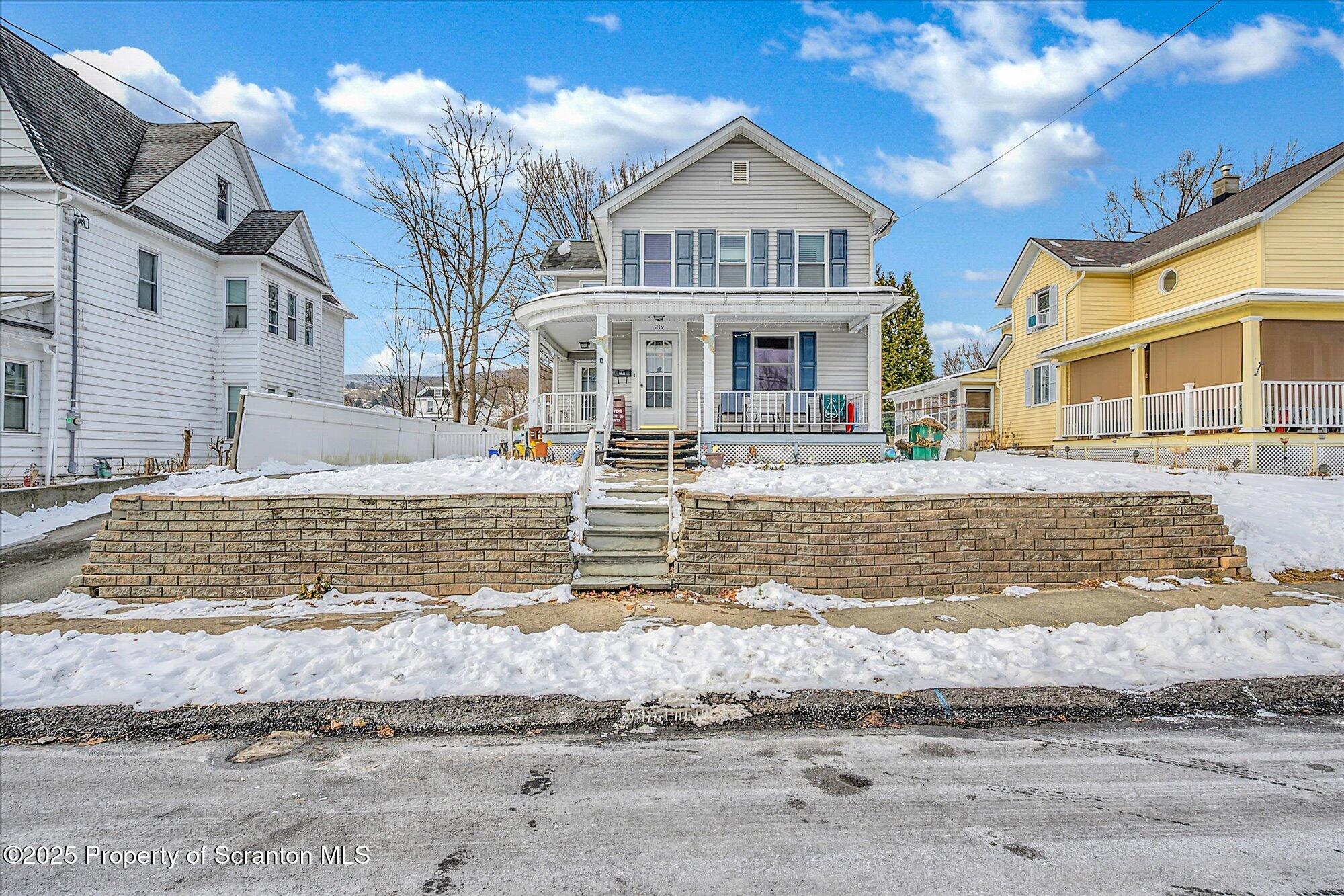 219 1st Street Olyphant, PA 18447 - Photo 2 of 43 a front view of a house with a yard