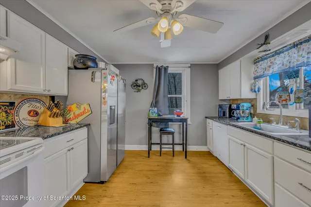a kitchen with stainless steel appliances granite countertop a sink and cabinets