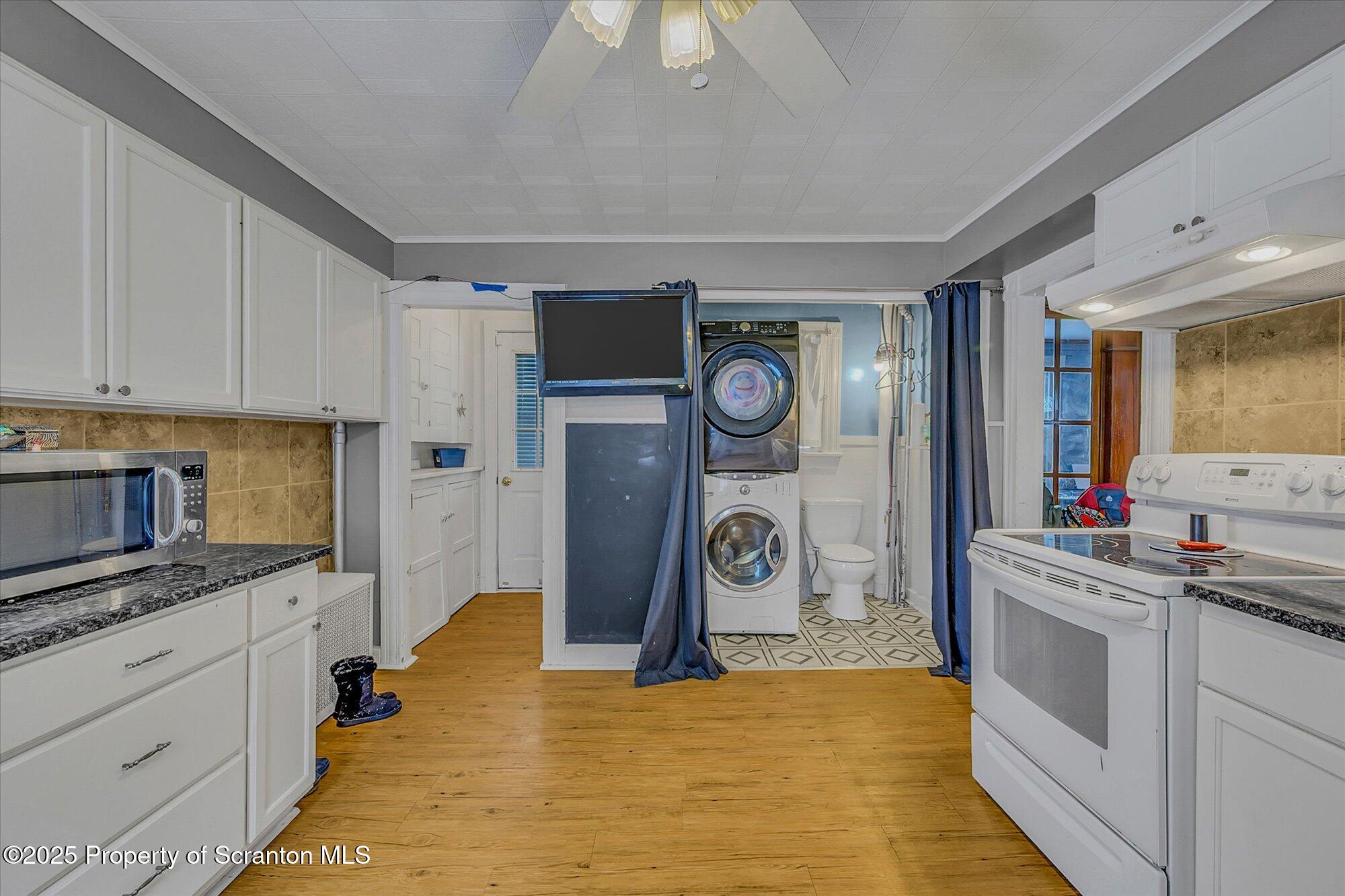 219 1st Street Olyphant, PA 18447 - Photo 26 of 43 a kitchen with a stove and a refrigerator