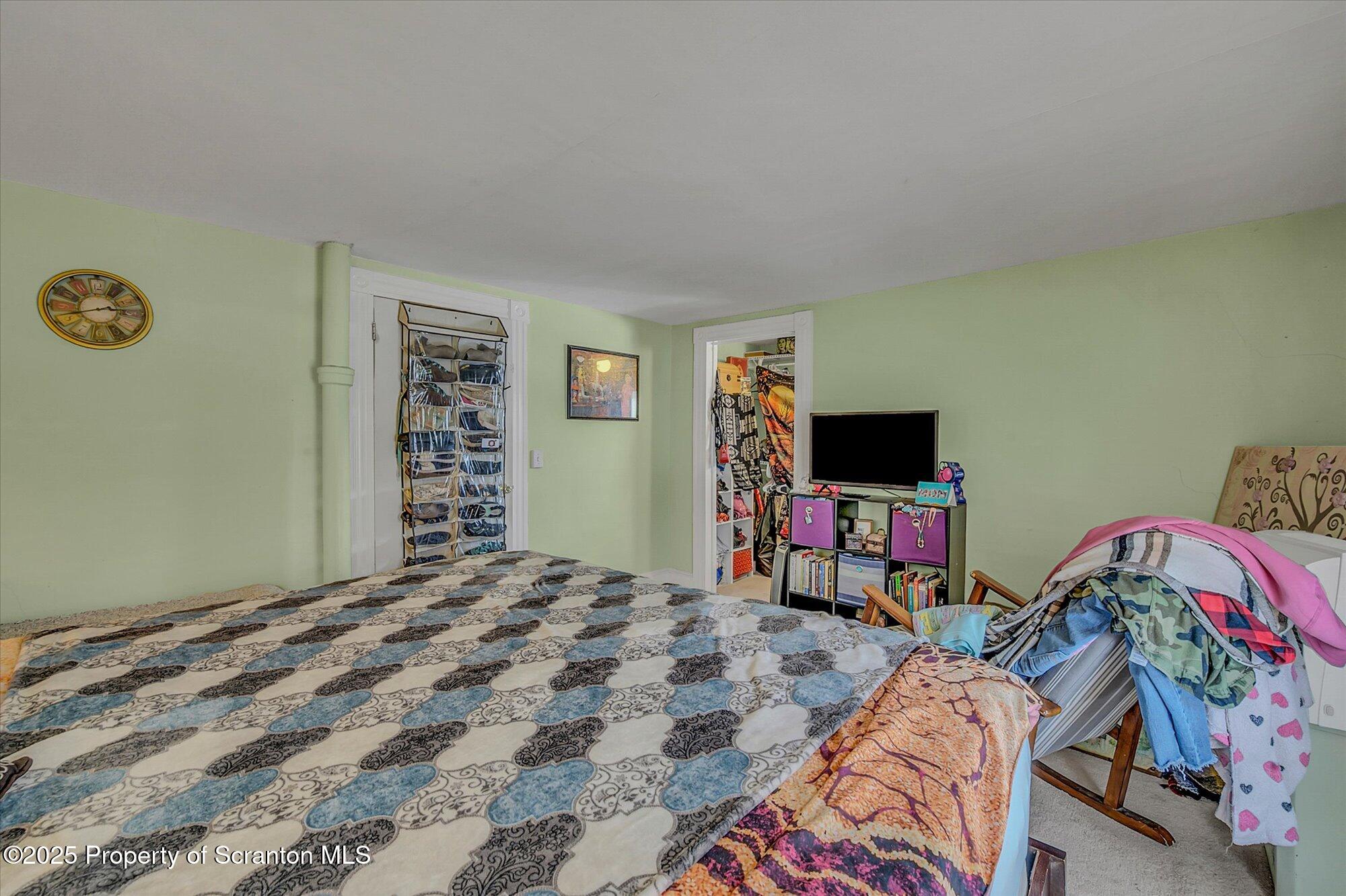 219 1st Street Olyphant, PA 18447 - Photo 31 of 43 a bedroom with a bed and a flat screen tv